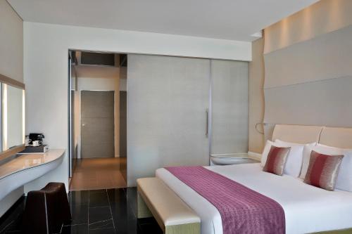 a hotel room with a bed and a bathroom at W Abu Dhabi - Yas Island in Abu Dhabi