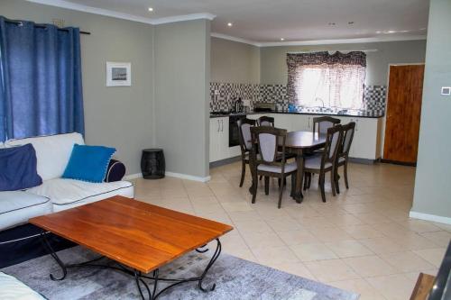 a living room with a couch and a table at House Samaika in Maun