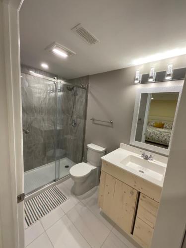 a bathroom with a shower and a toilet and a sink at Beautiful Unit in Nepean Ottawa in Ottawa