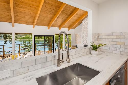 a kitchen with a stainless steel sink and a window at Agate Bridge Beauty in Agate Point