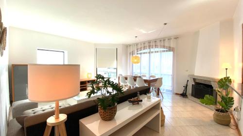 a living room with a couch and a table at Pleno Beach-side apartment Furadouro in Furadouro