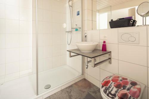 y baño con ducha y lavamanos. en Hotel Bären - the Alpine Herb Hotel, en Wengen