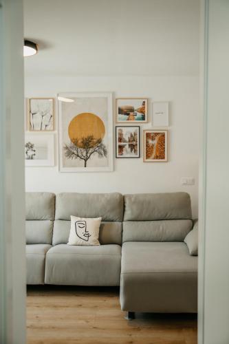 a living room with a couch and pictures on the wall at tuGuest Carretera de la Sierra Apartment in Granada