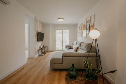a living room with a couch and a television at tuGuest Carretera de la Sierra Apartment in Granada