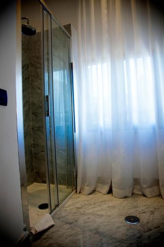 a bathroom with a shower with a glass door at Palazzo Papa Gregorio XVI in Tivoli