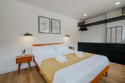 a bedroom with a large bed with towels on it at tuGuest Carretera de la Sierra Apartment in Granada