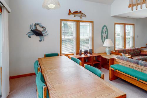 a dining room with a table and a couch at Siren's Song #D7-HC in Avon