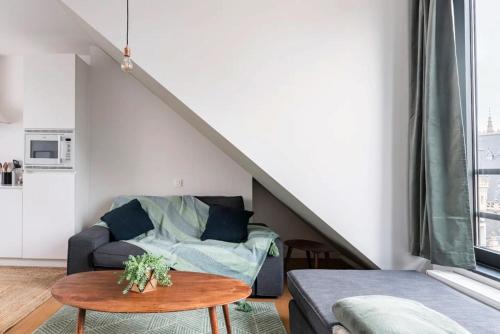 a living room with a couch and a table at New apartment with big terrace and great views! in Leuven