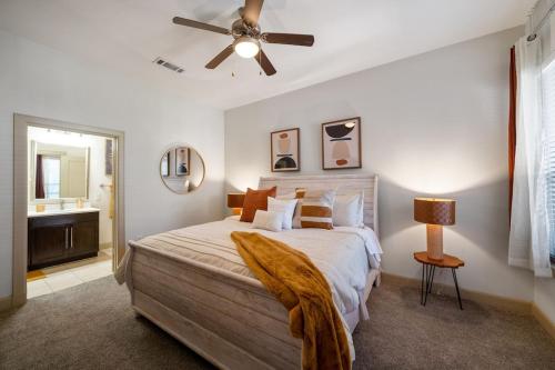 a bedroom with a bed and a ceiling fan at A Touch of Class in Houston