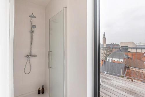 a shower in a bathroom with a view of a city at New apartment with big terrace and great views! in Leuven