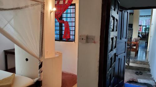 a door leading to a room with a window at 2 Bed House - Sleeps 3 - Pool - Parking - Wifi in Ukunda