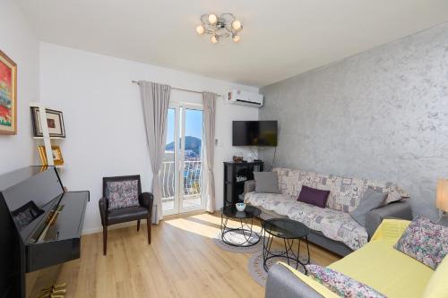 a living room with a couch and a table at Apartment Piano in Dubrovnik