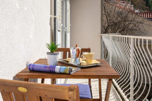 a wooden table with a book on top of it at Apartment Piano in Dubrovnik