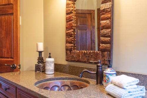 a bathroom counter with a sink and a mirror at Elk Island at River Run in Banner Elk