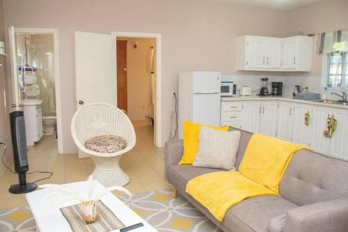 a living room with a couch and a kitchen at Gorgeous 2-Bed Apt Sleeps 3 in St Johns in Belmont