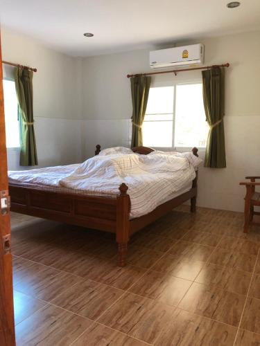 Postel nebo postele na pokoji v ubytování Thanid House