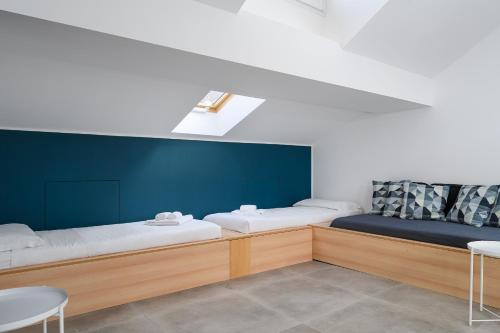 um quarto com duas camas e uma mesa e cadeiras em Design Attic porta venezia centrale 65m2 - self check-in em Milão