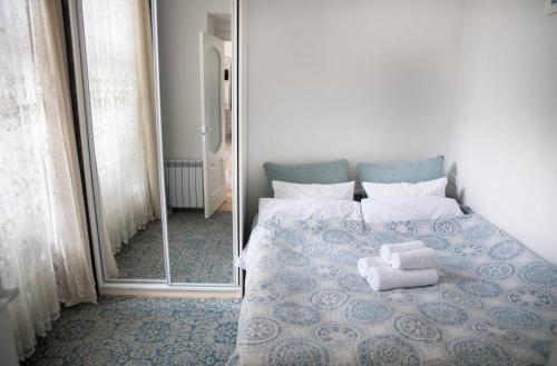 een slaapkamer met een blauw en wit bed en een spiegel bij Світла затишна квартира в центрі біля Оперного театру з балконом, який виходить у тихий львівський дворик in Lviv