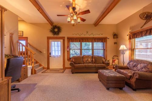 a living room with a couch and a ceiling fan at A Moon River View in Boone