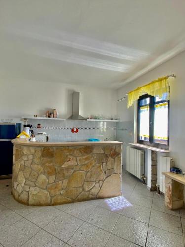 a kitchen with a stone counter and a window at Villa Ignoto in Bale