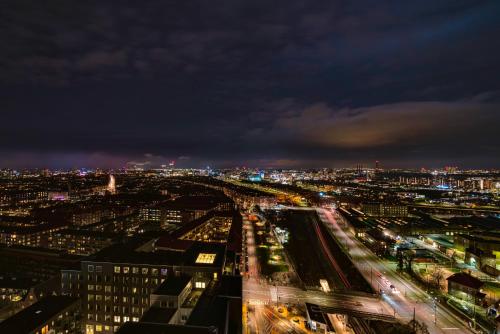 a view of a city at night with lights at Bohr Apartment Copenhagen in Copenhagen