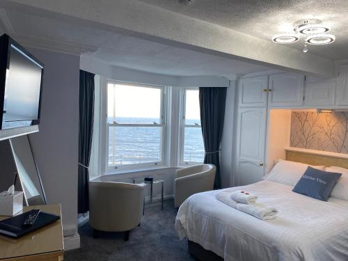 a hotel room with a bed and a window at Marine View Guest House in Scarborough