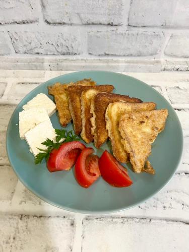 a plate of food with meat and cheese and strawberries at Kod Brke in Veliko Gradište