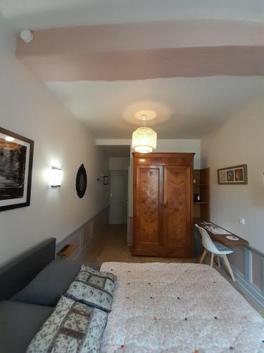 a bedroom with a large bed and a desk at Chambre d'hôtes indépendante in Fougères