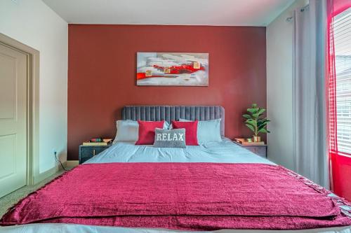 a bedroom with a large bed with a red wall at PackHouse NRG/MED Center in Houston