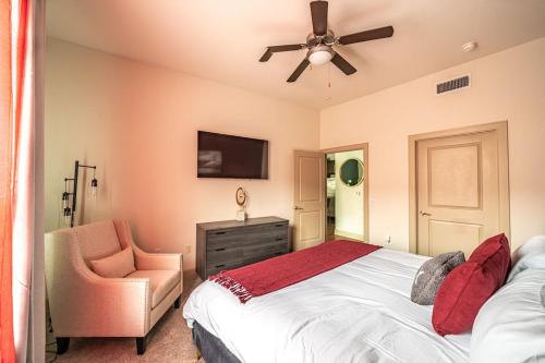 a bedroom with a bed and a chair and a ceiling fan at PackHouse NRG/MED Center in Houston