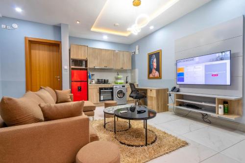 a living room with a couch and a tv at Cecilia Homes in Lekki