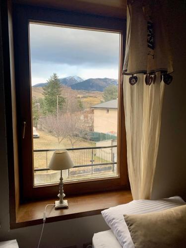 a bedroom with a window with a view of a mountain at Casa en Estavar Residential con jardín y piscina in Estavar