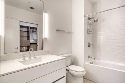 a white bathroom with a sink and a toilet at Coral Gables 1BR w WD Pool Gym nr Shops MIA-9 in Miami