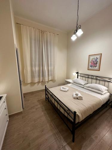a bedroom with a bed with two towels on it at Domo Achenza in Terralba
