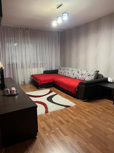 - un salon avec un lit et une couverture rouge dans l'établissement LorIli’s Home, à Drobeta-Turnu Severin