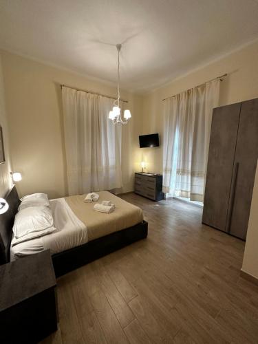 a bedroom with a bed and a dresser and a television at Domo Achenza in Terralba