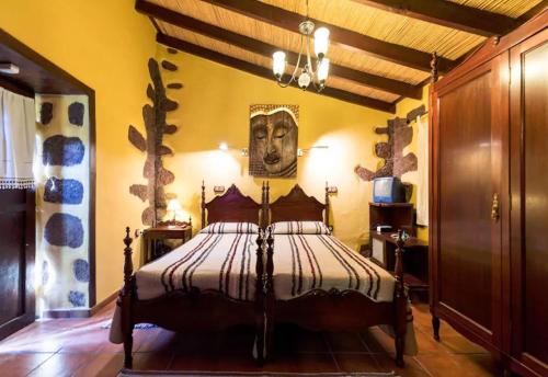 a bedroom with a bed with a picture on the wall at Bentayga Sensation with Pool in Tejeda