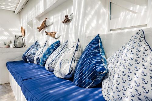 a blue and white couch with pillows on it at Bliss on the Bay in Struisbaai