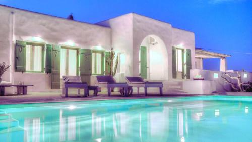 a house with a swimming pool in front of a house at Villa Maria Paros - A Unique & Luxurious Villa - Beach in Walking Distance in Molos Parou