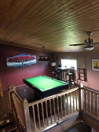a room with a pool table in a house at Chez Michel and Marilyn in Vernon