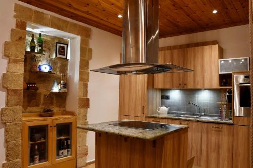 a kitchen with a sink and a stove at The three story old town house in Rhodes Town