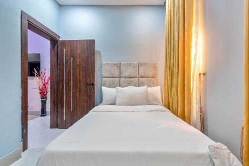 a bedroom with a large white bed in a room at Cecilia Homes in Lekki