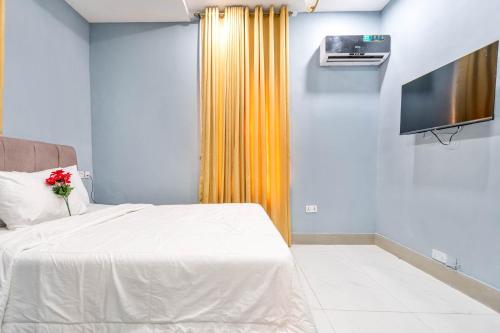 a bedroom with a bed and a tv on a wall at Cecilia Homes in Lekki
