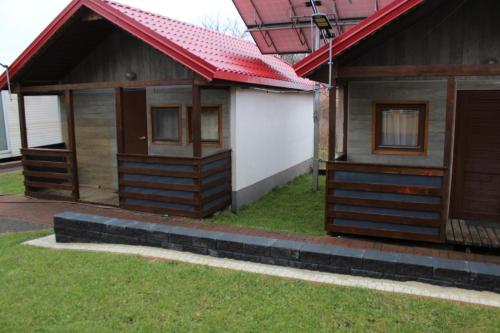 a small house with a red roof at Camping domki letniskowe in Warsaw