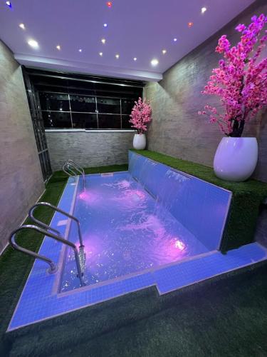 a jacuzzi tub in a room with purple lighting at Cecilia Homes in Lekki