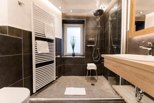 a bathroom with a sink and a toilet and a shower at Sauerländer Hof in Eslohe