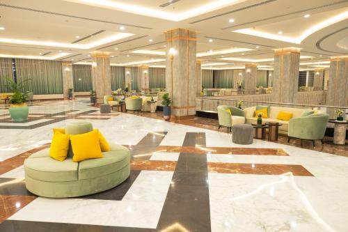 a lobby with a couch in the middle of a room at Tolip Olympic International City in New cairo