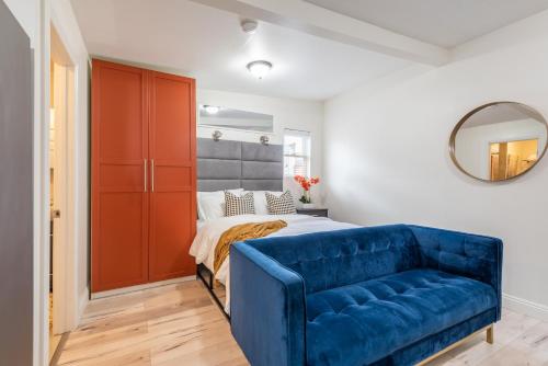 a bedroom with a bed and a blue couch at Private Guesthouse - Los Angeles in Los Angeles
