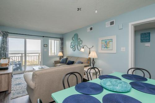 a living room with a table and chairs and a couch at Beach Therapy in Caswell Beach