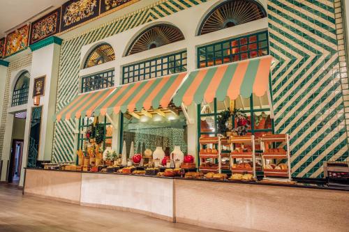 a store front with a display of food in a building at Iberostar Selection Hacienda Dominicus - All Inclusive in Bayahibe